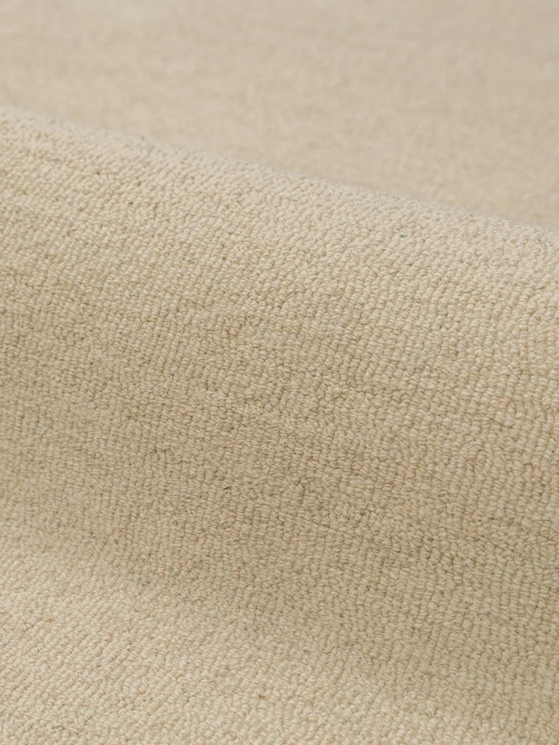 Wollteppich mit Wellenrand · handgetuftet, 5 mm Flor · 3.250 g/m²