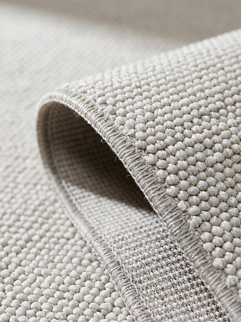 Waschbarer Flachgewebe-Teppich · Bouclé-Look · 100 % recyceltes Polyester · Hellgrau