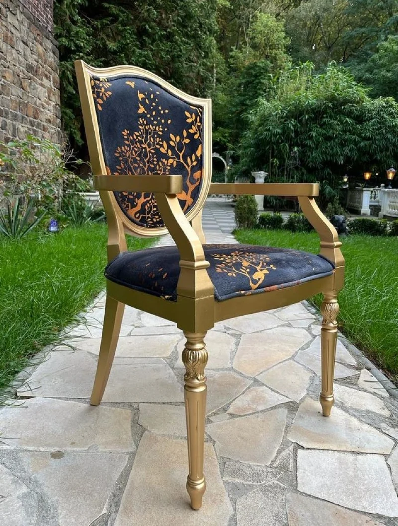 Casa Padrino Luxus Art Deco Esszimmer Stuhl Schwarz / Gold - Eleganter Massivholz Stuhl mit Armlehnen - Art Deco Esszimmer Möbel